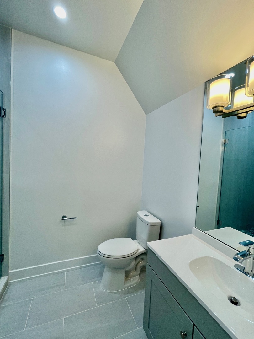 2238 West 24th Street, Unit 2F Chicago, IL 60608 - Photo 21 of 25 a bathroom with a sink a toilet and mirror