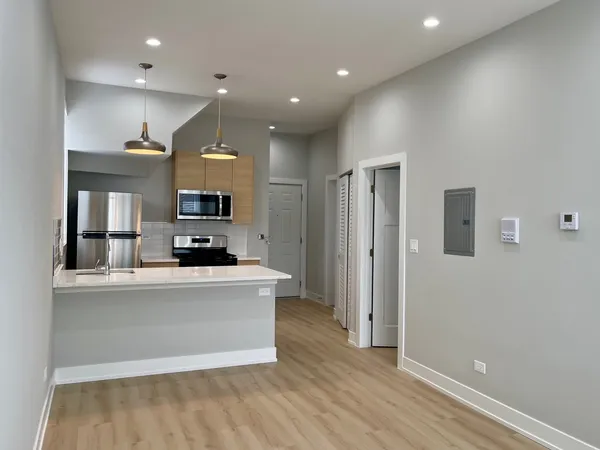 a kitchen with stainless steel appliances a refrigerator and a stove top oven