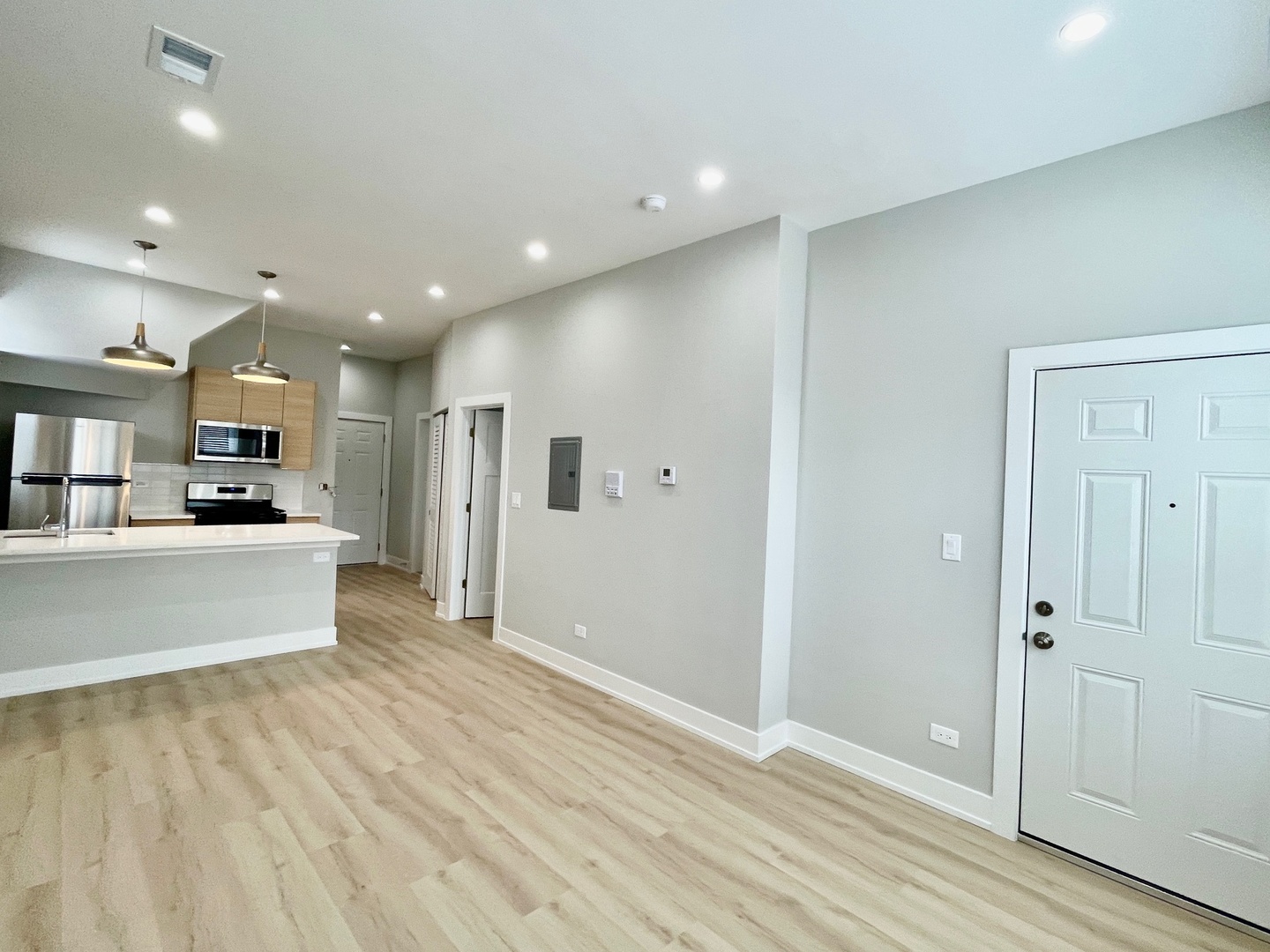 2238 West 24th Street, Unit 2F Chicago, IL 60608 - Photo 6 of 25 a view of a kitchen with kitchen island wooden floor center island and stainless steel appliances
