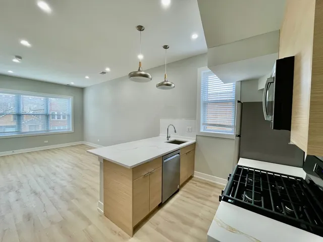 a kitchen that has a sink and a stove in it