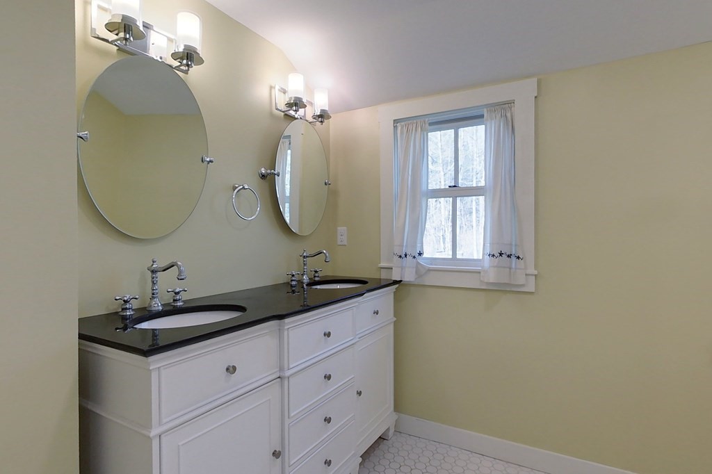 95 South Road Ashby, MA 01431 - Photo 14 of 33 a bathroom with a double vanity sink and a mirror