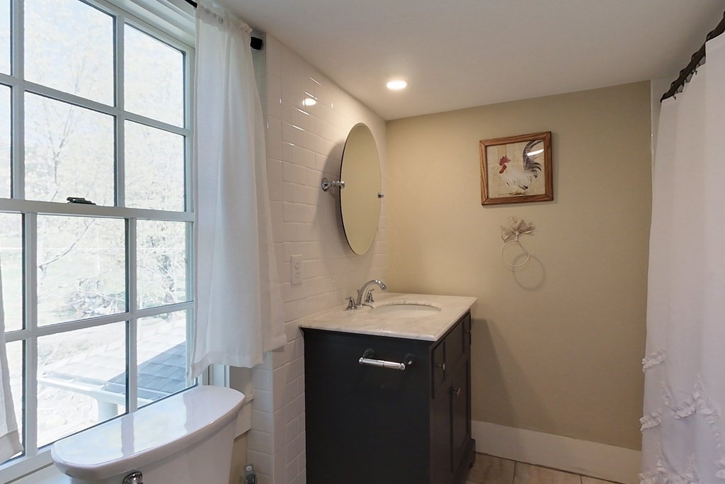 95 South Road Ashby, MA 01431 - Photo 20 of 33 a bathroom with a sink a mirror and a window