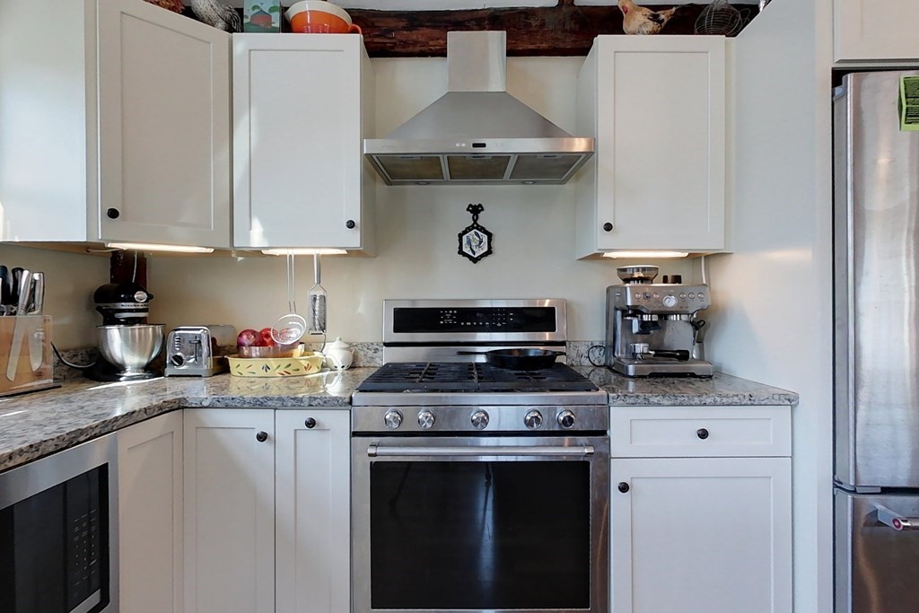 95 South Road Ashby, MA 01431 - Photo 3 of 33 a kitchen with stainless steel appliances a stove and white cabinets