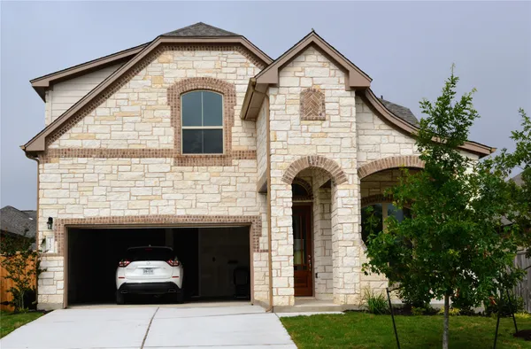 a front view of a house with a yard and garage