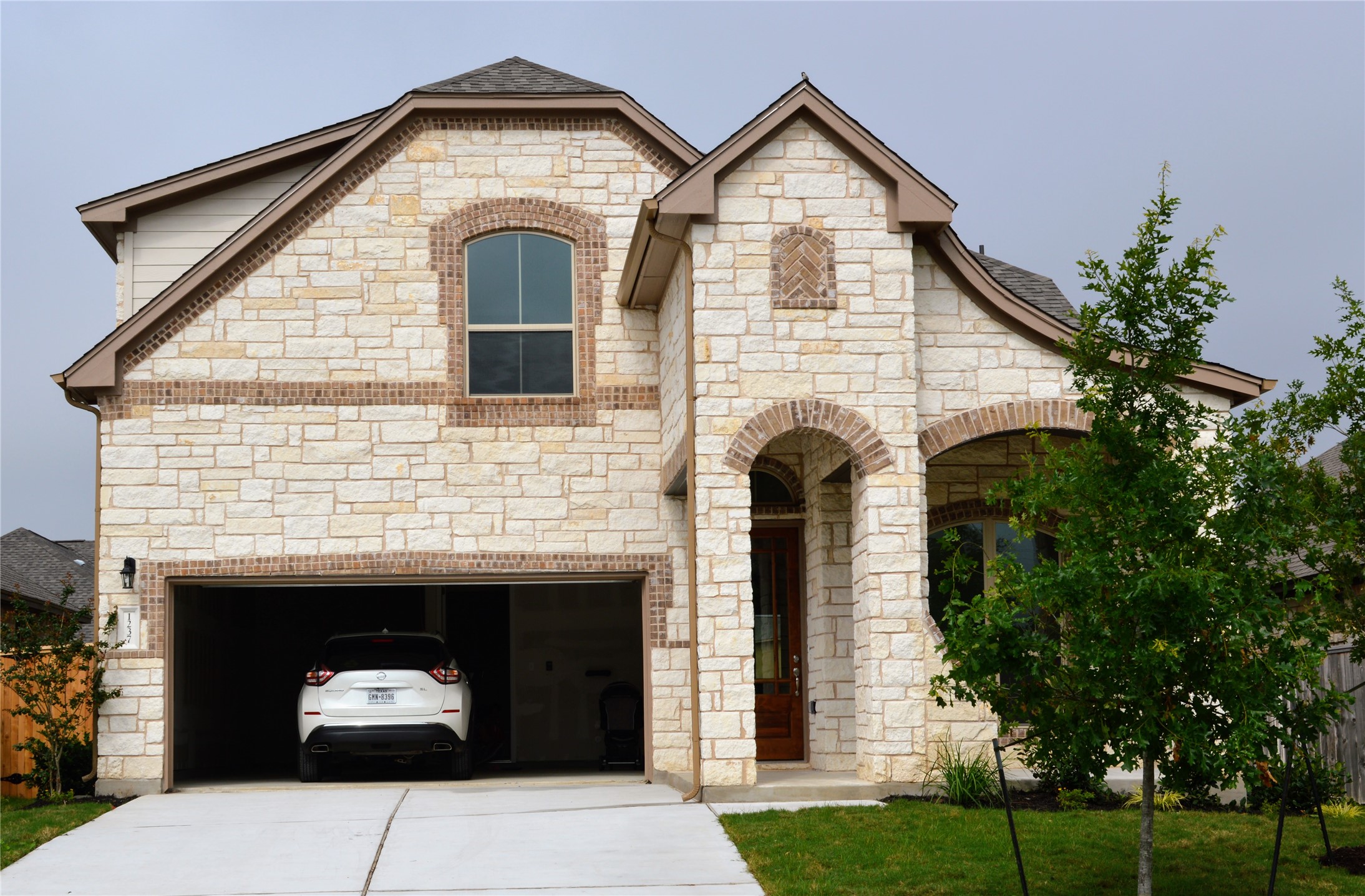 a front view of a house with a yard and garage