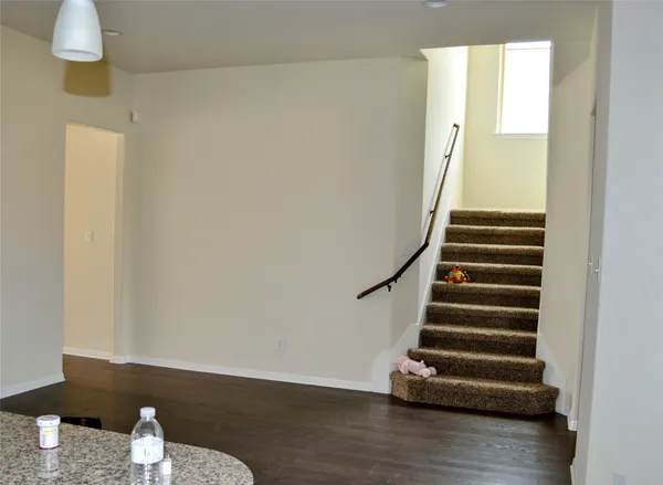 a view of entryway with stairs and wooden floor