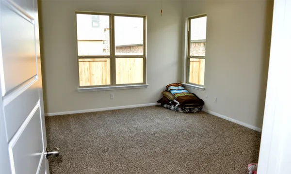 a room with a window and a chair