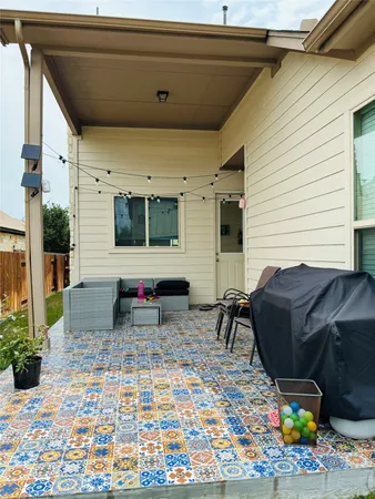 a view of a patio with a table and chairs