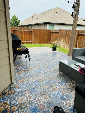 a view of a house with backyard and a patio