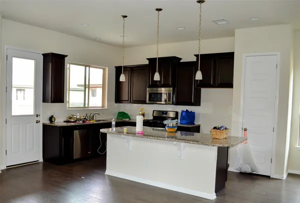 a view of kitchen with cabinets and wooden floor