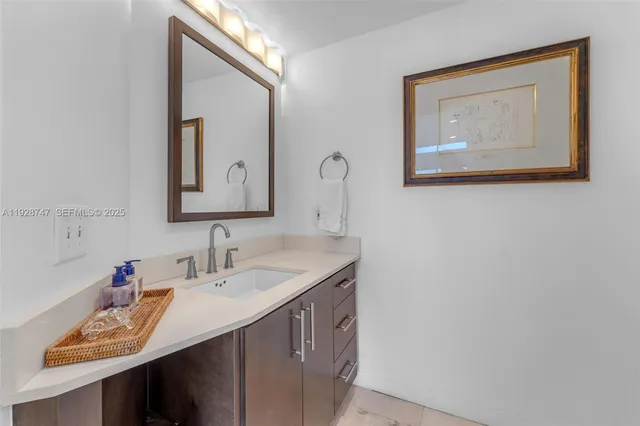 a bathroom with a sink a toilet a mirror and shower