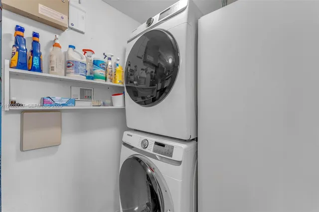 a spacious bedroom with a large bed and a chandelier