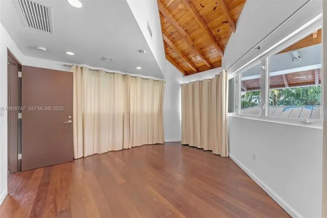 a bathroom with a tub and toilet