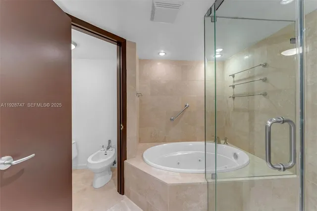 a bedroom with a large bed and a large window