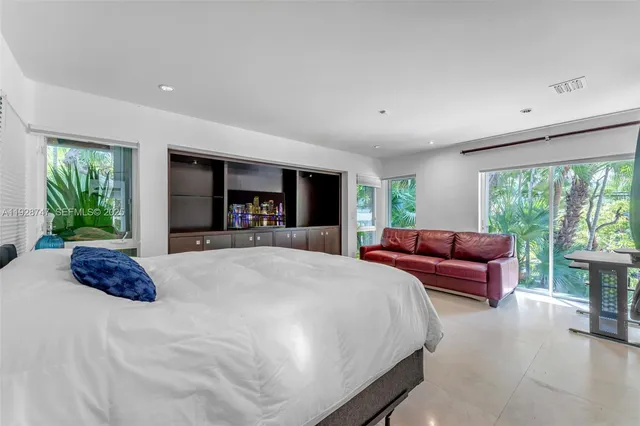 a front view of a house with a yard and potted plants