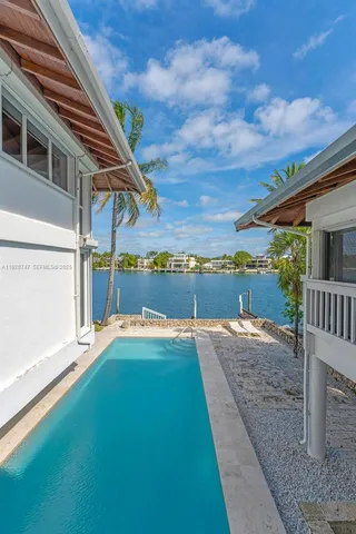 an aerial view of a house with a yard swimming pool and outdoor seating