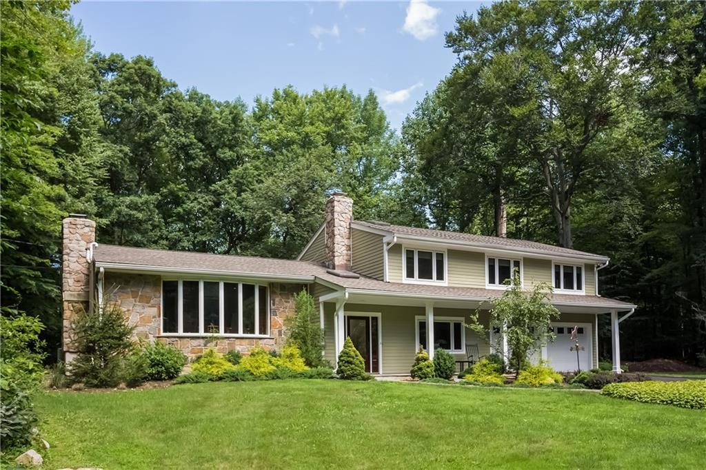 163 Linden Tree Road Wilton, CT 06897 - Photo 1 of 1 a front view of a house with a yard and trees