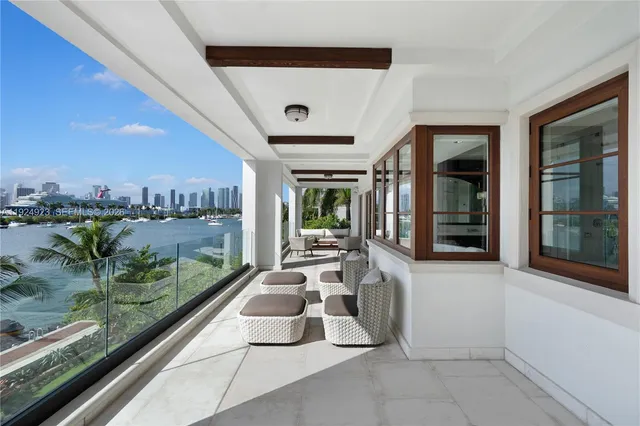 a large kitchen with kitchen island a large window in it