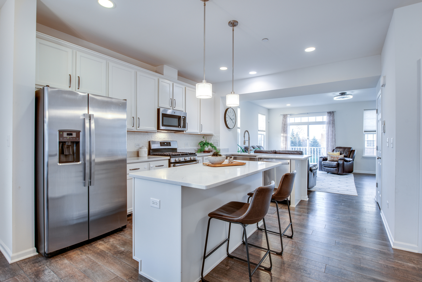 4477 Monroe Court Naperville, IL 60564 - Photo 7 of 23 a kitchen with stainless steel appliances a refrigerator a stove a sink a dining table and chairs