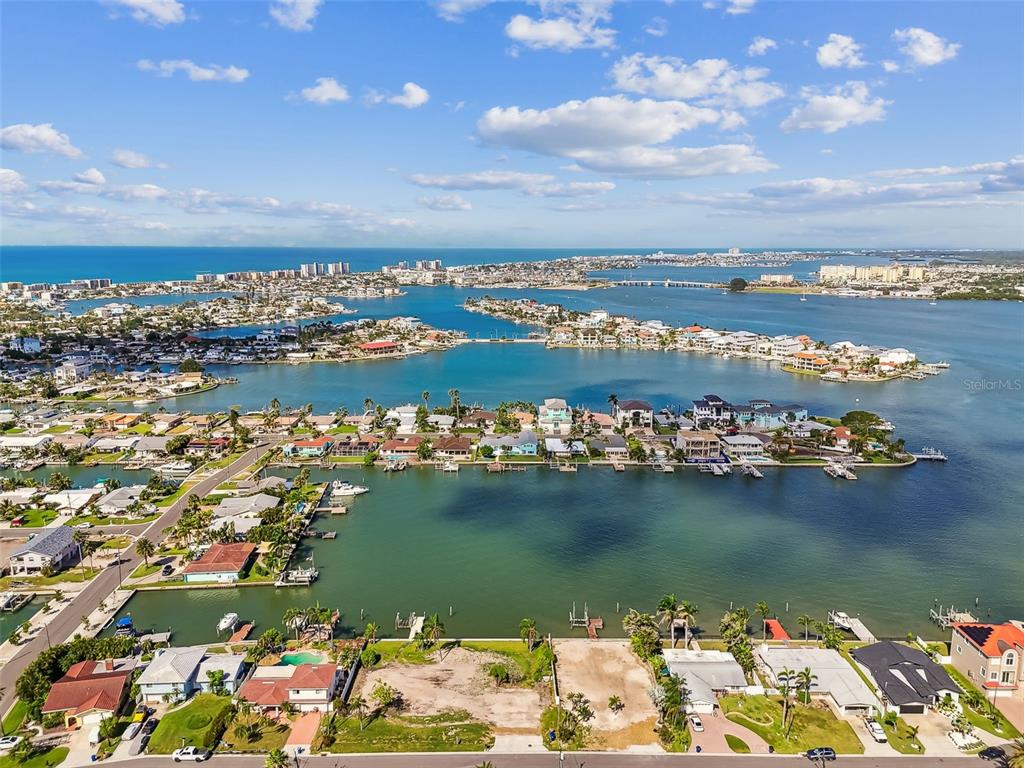 568 Johns Pass Avenue Madeira Beach, FL 33708 - Photo 19 of 36 an aerial view of a city with lots of residential buildings ocean and mountain view in back