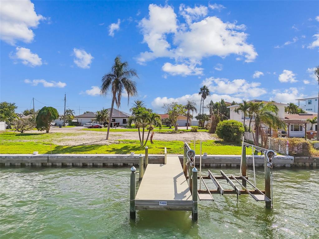 568 Johns Pass Avenue Madeira Beach, FL 33708 - Photo 4 of 36 a swimming pool with outdoor seating and yard