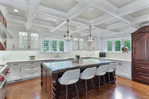 a living room with furniture wooden floor and a large window