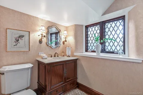 a en suite bathroom with a granite countertop sink and a mirror
