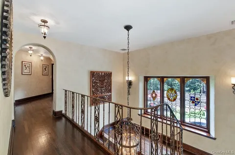 a bedroom with a bed a chandelier and closet