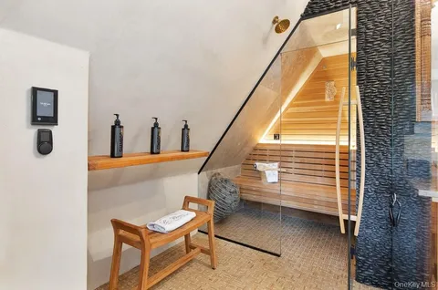 a bathroom with a bathtub double vanity sink and mirror
