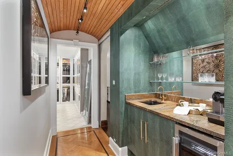 a bathroom with a sink a mirror a vanity and shower