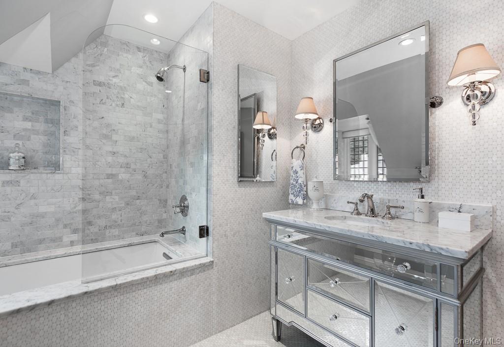 21 Hampshire Road Bronxville, NY 10708 - Photo 30 of 41 a bathroom with a bathtub double vanity sink and mirror