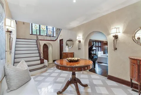 a living room with furniture a mirror and a fireplace