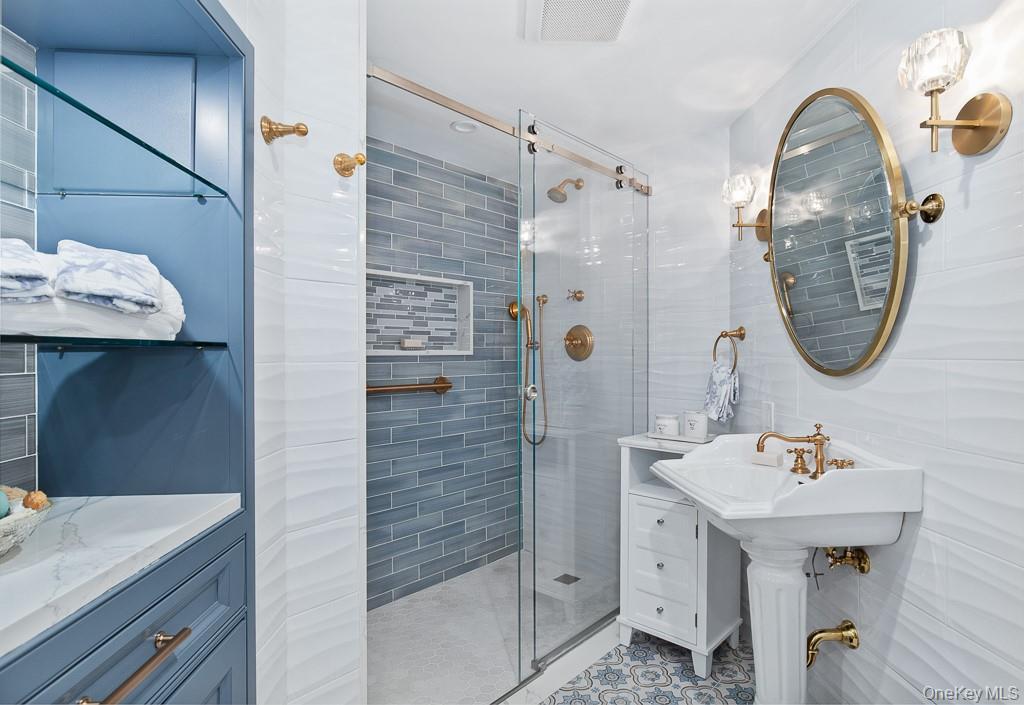 21 Hampshire Road Bronxville, NY 10708 - Photo 34 of 41 a bathroom with a sink a mirror a vanity and shower