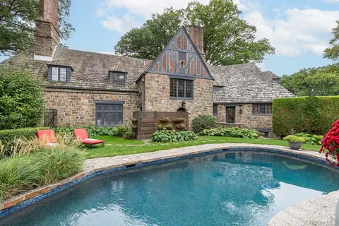 a aerial view of a house with swimming pool and a yard