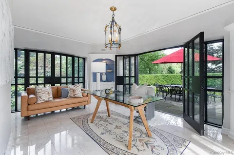 a dining room with furniture and window