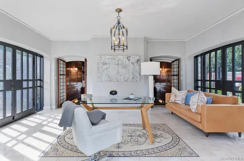 a view of a dining room with furniture a chandelier and wooden floor