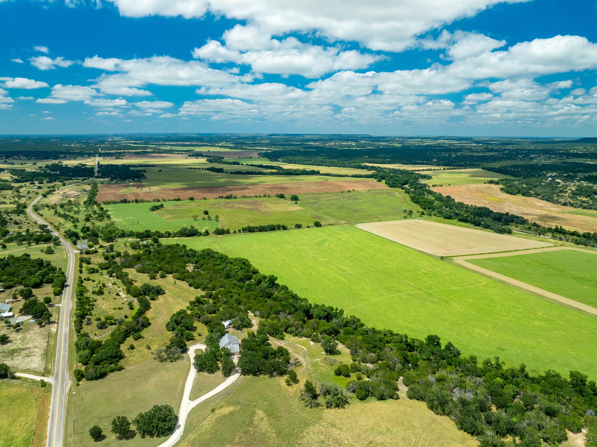 8044 580th Street East Kempner, TX 76539 - Photo 2 of 40 An aerial panorama showcases vast rural acreage with lush green fields and winding roadways.