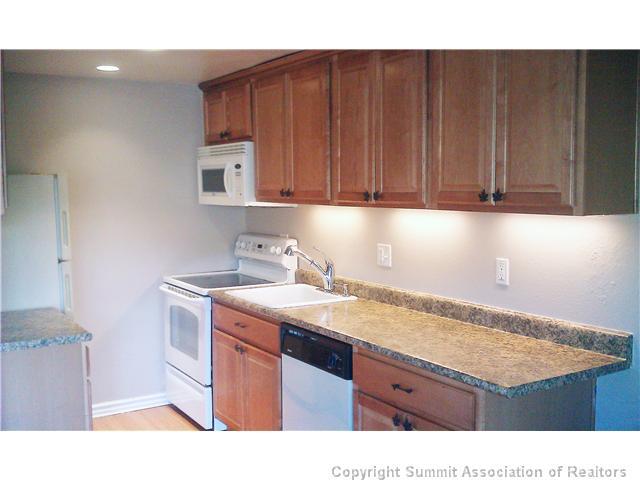 110 Evergreen Road, Unit 202 Dillon, CO 80435 - Photo 2 of 10 a kitchen with a sink cabinets and wooden floor