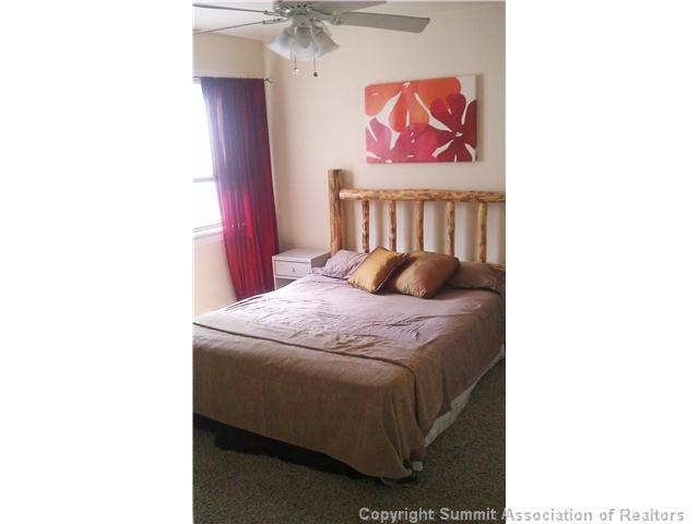 110 Evergreen Road, Unit 202 Dillon, CO 80435 - Photo 3 of 10 a bedroom with a bed and a painting on the wall