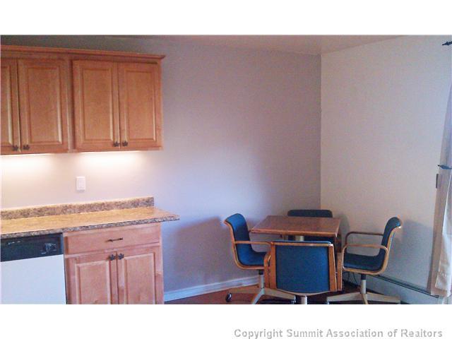 110 Evergreen Road, Unit 202 Dillon, CO 80435 - Photo 4 of 10 a kitchen with a sink cabinets and wooden floor