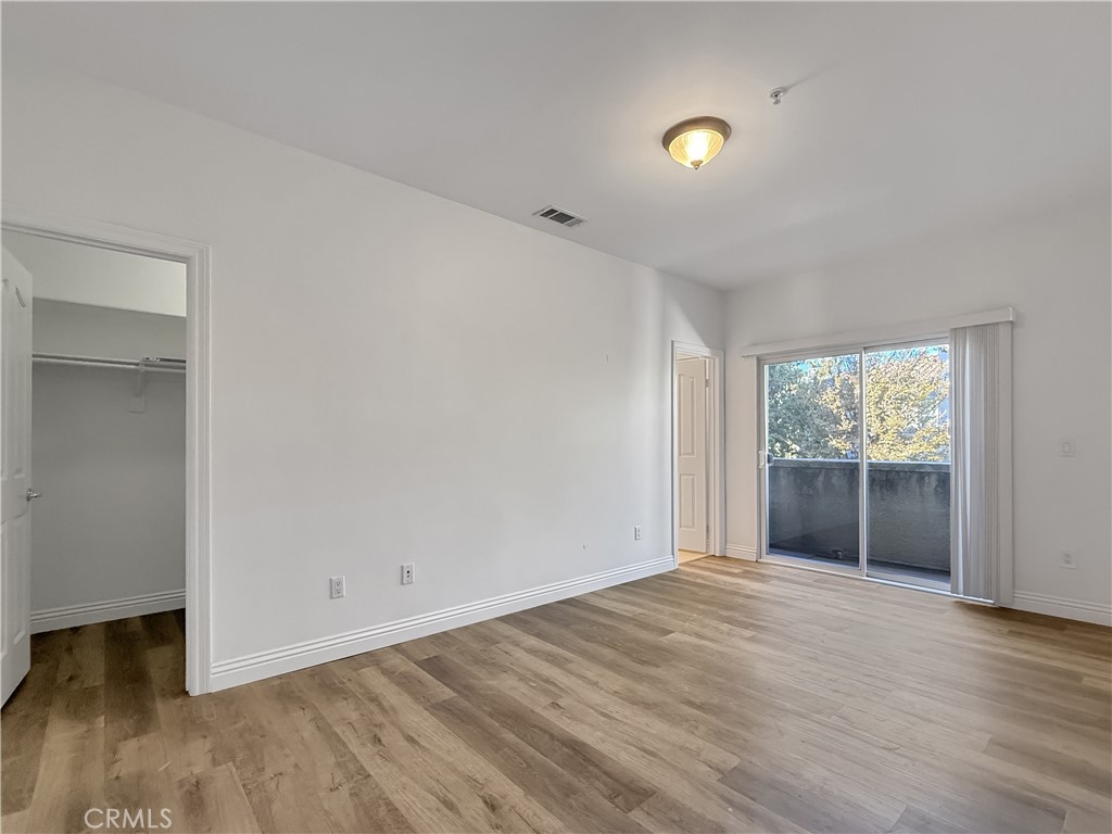 255 North Michigan Avenue, Unit 4 Pasadena, CA 91106 - Photo 12 of 20 an empty room with wooden floor and windows