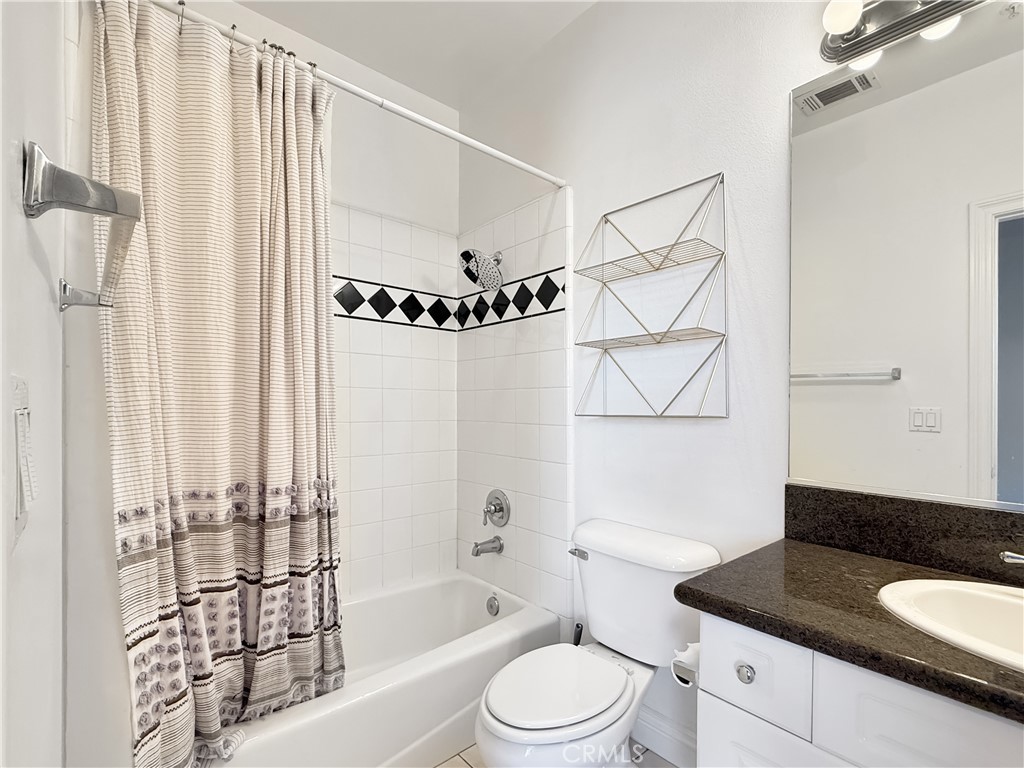 255 North Michigan Avenue, Unit 4 Pasadena, CA 91106 - Photo 14 of 20 a bathroom with a granite countertop bathtub sink vanity mirror and toilet