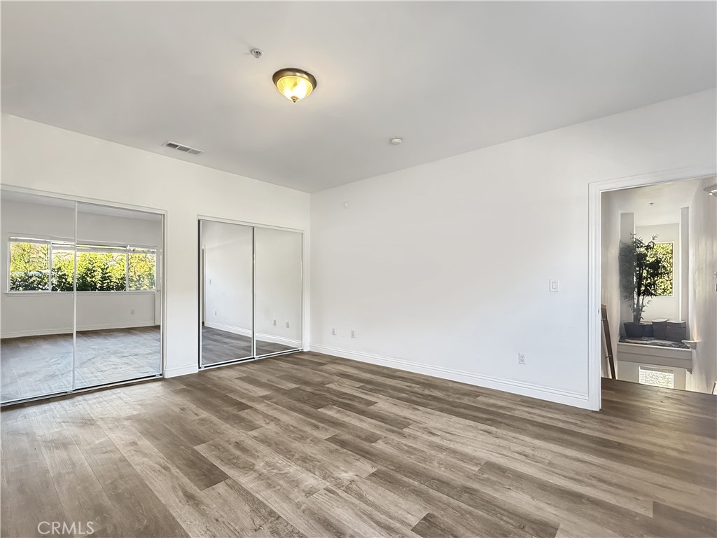255 North Michigan Avenue, Unit 4 Pasadena, CA 91106 - Photo 16 of 20 an empty room with wooden floor and windows