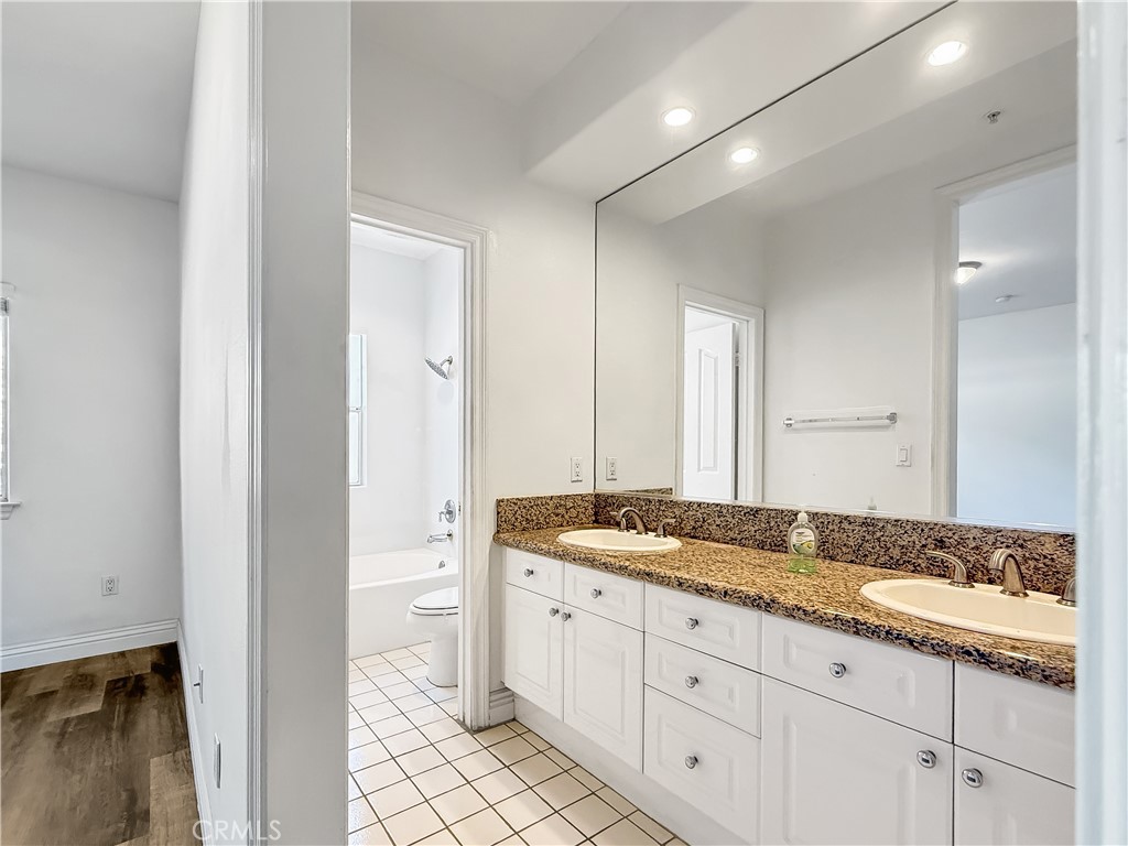 255 North Michigan Avenue, Unit 4 Pasadena, CA 91106 - Photo 17 of 20 a bath room with a granite countertop sink and a mirror