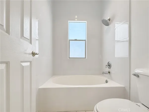 a white bath tub sitting next to a white toilet