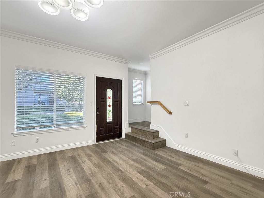 255 North Michigan Avenue, Unit 4 Pasadena, CA 91106 - Photo 5 of 20 a view of an empty room with wooden floor and a window