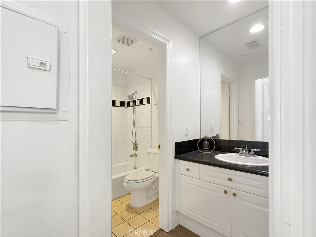 255 North Michigan Avenue, Unit 4 Pasadena, CA 91106 - Photo 9 of 20 a bathroom with a granite countertop sink and a mirror
