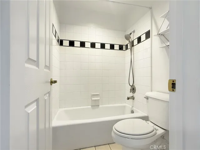 a bathroom with a toilet and a bathtub