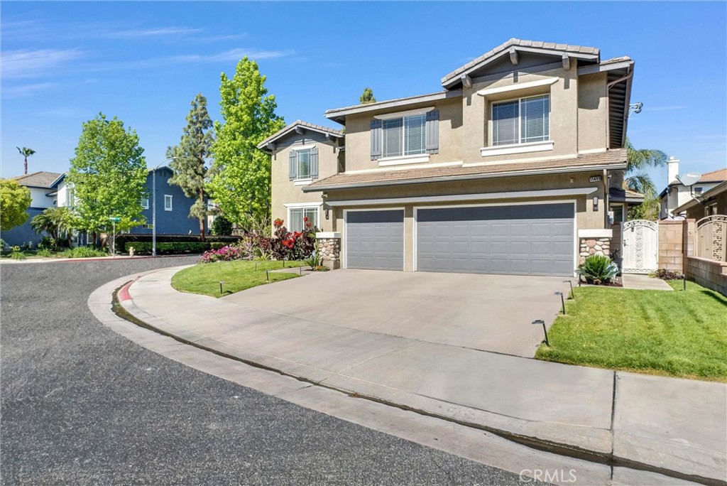 11499 Bridgeway Drive Riverside, CA 92505 - Photo 2 of 70 a front view of a house with a yard and garage