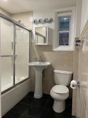 1503 76th Street, Unit 2 North Bergen, NJ 07047 - Photo 11 of 11 a white toilet sitting next to a bathroom sink